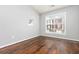 Empty Bedroom features hardwood floors, a window, and a wall decal at 786 Brookside Parc Ln, Avondale Estates, GA 30002
