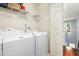 This laundry room provides great space for a washer and dryer with storage shelves at 786 Brookside Parc Ln, Avondale Estates, GA 30002
