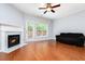 Light-filled living room with hardwood floors, a fireplace, and access to the backyard at 786 Brookside Parc Ln, Avondale Estates, GA 30002