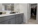 Bathroom featuring double sinks, granite countertops, and a walk-in closet at 9913 Stretford Rd, Douglasville, GA 30135