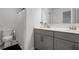 Bathroom features a double sink vanity, gray cabinetry, and a shower-tub combo at 9913 Stretford Rd, Douglasville, GA 30135