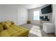 Bedroom with large windows, a yellow chaise lounge, and a built-in workspace at 9913 Stretford Rd, Douglasville, GA 30135