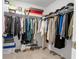 Walk-in closet with ample storage space, including shelves and rods for hanging clothes at 9913 Stretford Rd, Douglasville, GA 30135