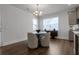 Cozy dining area featuring hardwood floors, modern chandelier, and ample natural light at 9913 Stretford Rd, Douglasville, GA 30135