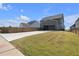 View of the house and driveway, highlighting the spacious lawn and two-car garage at 9913 Stretford Rd, Douglasville, GA 30135