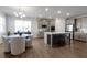 Spacious kitchen with gray cabinets, island with seating, and a connected dining area with bright windows at 9913 Stretford Rd, Douglasville, GA 30135