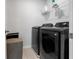 Convenient laundry room with stainless steel appliances and extra storage space at 9913 Stretford Rd, Douglasville, GA 30135