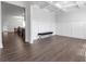 Spacious living room with hardwood floors, white walls, a padded bench, and decorative ceiling at 9913 Stretford Rd, Douglasville, GA 30135