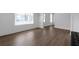 Bright living room with hardwood floors, white walls, wainscoting and ample natural light at 9913 Stretford Rd, Douglasville, GA 30135