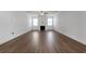 Bright living room features hardwood floors, a ceiling fan, and a charming fireplace at 9913 Stretford Rd, Douglasville, GA 30135
