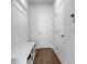 Bright mudroom with built-in bench, shoe storage, and convenient coat hooks at 9913 Stretford Rd, Douglasville, GA 30135