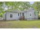 Charming home exterior with siding, a grassy yard, and wooden stairs to entrance at 1723 Ritcherson Se St, Marietta, GA 30060