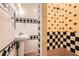 This charming bathroom features unique tiling and a pedestal sink at 1723 Ritcherson Se St, Marietta, GA 30060