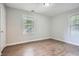 A bedroom with light-colored walls and wood-look flooring, illuminated by two windows at 1723 Ritcherson Se St, Marietta, GA 30060