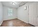 This bedroom features wood-look flooring and a bright window for ample natural light at 1723 Ritcherson Se St, Marietta, GA 30060