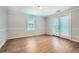 Bright bedroom with wood floors, double doors leading to a balcony or patio, and fresh paint at 1723 Ritcherson Se St, Marietta, GA 30060
