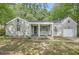 Charming one-story home with brick facade, covered porch, attached garage and mature trees at 1723 Ritcherson Se St, Marietta, GA 30060
