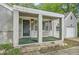 This one-story home features a covered front porch with brick columns and a single-car garage at 1723 Ritcherson Se St, Marietta, GA 30060