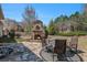 Backyard patio featuring stone fireplace, seating area and manicured lawn at 233 Millstone Pkwy, Woodstock, GA 30188