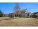 Wide view of the house and backyard showing the stone fireplace feature at 233 Millstone Pkwy, Woodstock, GA 30188