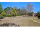 Wide open backyard with stone path, trees and well-maintained lawn at 233 Millstone Pkwy, Woodstock, GA 30188