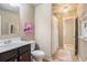 Cozy bathroom featuring a vanity with dark cabinetry, artwork, and a shower at 233 Millstone Pkwy, Woodstock, GA 30188