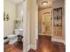 Traditional half bathroom with wood floors and decorative wall art at 233 Millstone Pkwy, Woodstock, GA 30188