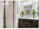 Bathroom with decorative mirror, single sink vanity, and neutral colors at 233 Millstone Pkwy, Woodstock, GA 30188