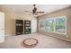 Bedroom with ceiling fan and natural light from the row of windows at 233 Millstone Pkwy, Woodstock, GA 30188