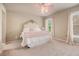 Bright bedroom with plush carpeting, ceiling fan, and large decorative headboard at 233 Millstone Pkwy, Woodstock, GA 30188