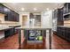 Gourmet kitchen with a large island, dark cabinets, and granite countertops at 233 Millstone Pkwy, Woodstock, GA 30188
