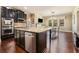 Modern kitchen featuring an island, stainless steel appliances, and dark cabinets at 233 Millstone Pkwy, Woodstock, GA 30188