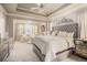 Spacious main bedroom suite with sitting area, trey ceiling, and ample natural light at 233 Millstone Pkwy, Woodstock, GA 30188