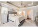 Elegant main bedroom with tufted headboard, chandelier, and adjoining bathroom at 233 Millstone Pkwy, Woodstock, GA 30188