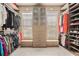 Custom walk-in closet with built-in shelving and storage at 233 Millstone Pkwy, Woodstock, GA 30188