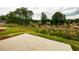 Spacious backyard with a concrete patio, grassy area, and lush greenery at 358 Forkview Dr, Lawrenceville, GA 30044