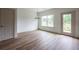 Bright dining area with hardwood floors, a modern chandelier, large windows, and access to the patio at 358 Forkview Dr, Lawrenceville, GA 30044