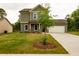 Two-story home with green siding, a well-kept lawn, covered porch, and attached two car garage at 358 Forkview Dr, Lawrenceville, GA 30044