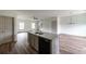 Open floor plan featuring a kitchen island overlooking the living area with hardwood floors and natural light at 358 Forkview Dr, Lawrenceville, GA 30044