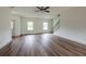 Open-concept living area with wood floors, ample natural light, staircase, and a view of the backyard at 358 Forkview Dr, Lawrenceville, GA 30044