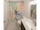 Bathroom with a marble vanity top and decorative shower curtain at 485 Sherman Way, Decatur, GA 30033