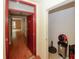 Inviting entryway with red door leading to a hallway with hardwood floors at 485 Sherman Way, Decatur, GA 30033