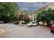 Exterior view showing a complex with ample parking and lush trees in a neighborhood with well-maintained landscaping at 485 Sherman Way, Decatur, GA 30033