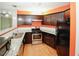 Bright kitchen features stainless steel appliances, granite countertops, wood floors and dark wood cabinets at 485 Sherman Way, Decatur, GA 30033
