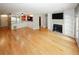 Open living room with hardwood flooring, fireplace, and seamless transition to the dining space at 485 Sherman Way, Decatur, GA 30033