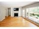 Inviting living room featuring hardwood floors, fireplace, natural light, and access to the deck at 485 Sherman Way, Decatur, GA 30033
