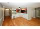 Open-concept living area features hardwood floors and a pass-through to the kitchen area with modern lighting at 485 Sherman Way, Decatur, GA 30033