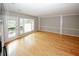 Light-filled living room featuring hardwood floors, neutral walls, and direct access to the balcony at 485 Sherman Way, Decatur, GA 30033