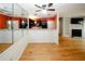 Stylish living area boasting hardwood floors, fireplace, kitchen view and mirror accents at 485 Sherman Way, Decatur, GA 30033