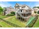 Backyard featuring multi-level deck, stairs, lush green grass, and fenced yard at 5826 Sarazen Trl, Douglasville, GA 30135